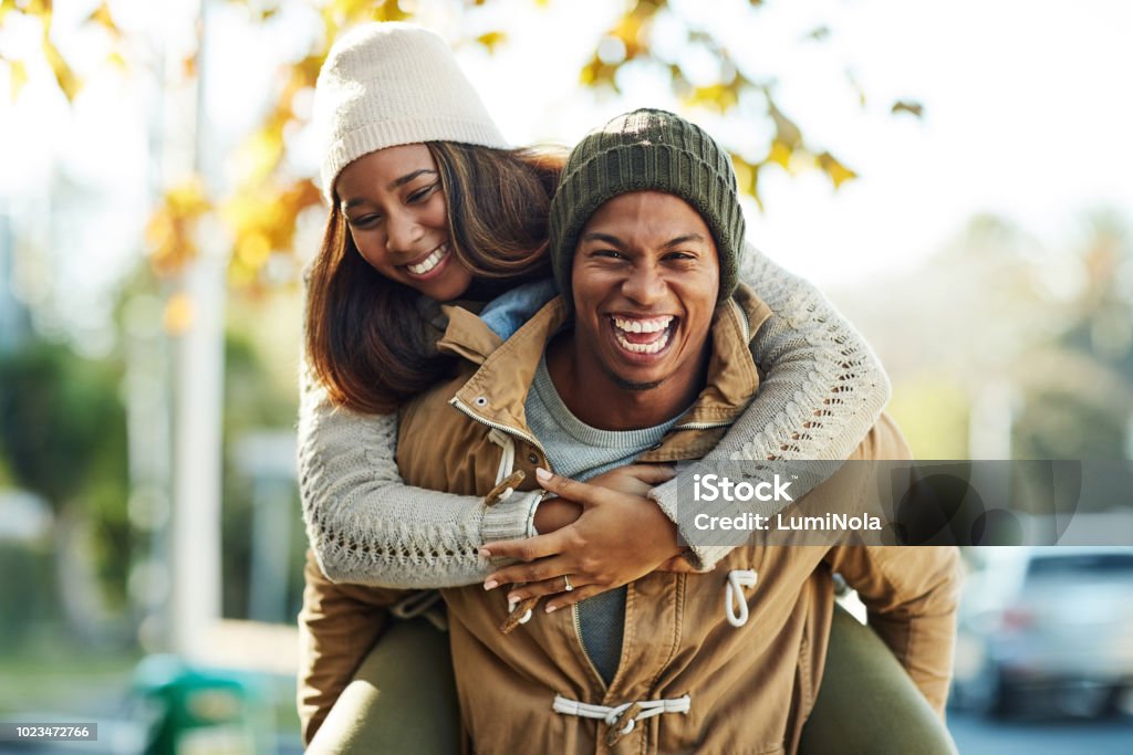Portrait of a young attractive couple outside wearing sweaters and hats